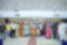Photograph of a large group of men, women, and children posing indoors at India Street Vendor Forum 2025 event, as indicated by a banner in background. Participants wear colorful traditional and formal attire with name badges, standing on a tiled floor with a red carpet runner in center.