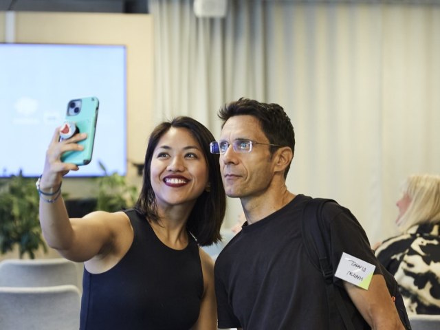 A man and women taking a selfie together at an event