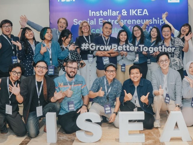 A group of people standing together with the I-SEA sign