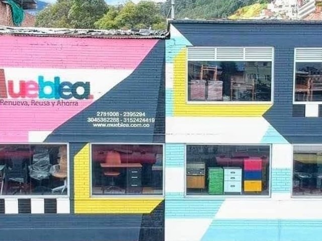 An three-story office building painted with bright geometric graffiti