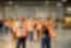 A group of people in safety vests walking through a factory