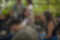 A group of people engaged in conversation at a social event with a lively and attentive atmosphere.